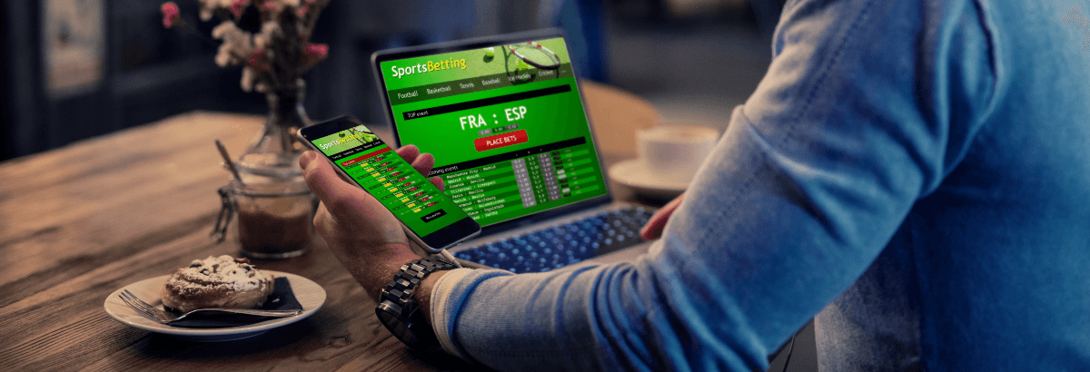 Sports betting on a laptop and phone