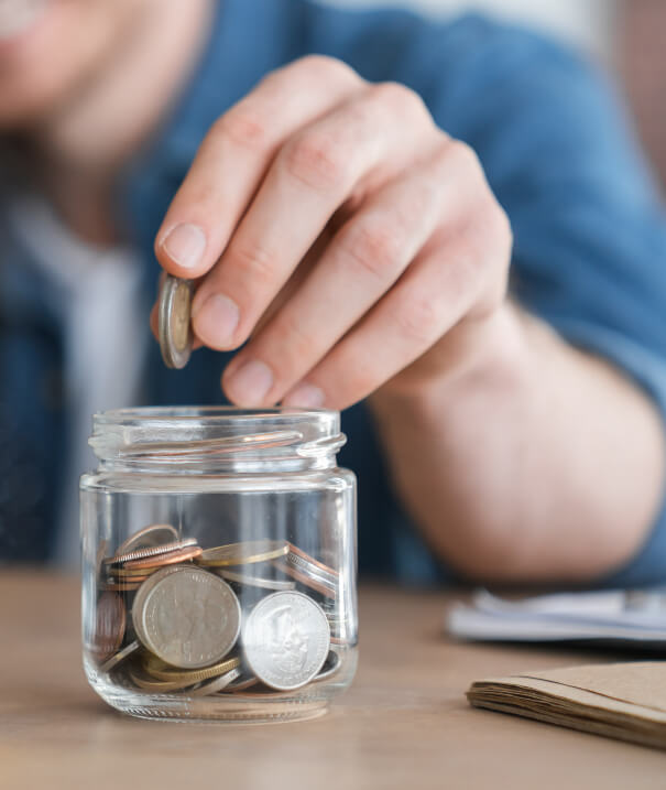 Coins being put in a jar